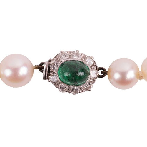 88 - A cultured pearl necklace, the pearls measuring approximately 6mm-7.7mm, leading to a cabochon emera... 