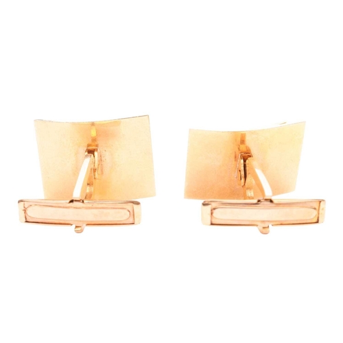 98 - A pair of cufflinks of abstract design, curved metal sheets in satin finish pinching a bead, toggle ... 