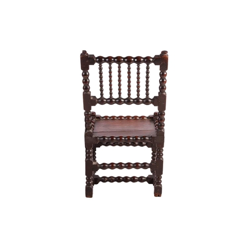 108 - A William III bobbin-turned oak back stool with a floating panel seat, the underframe of conforming ... 