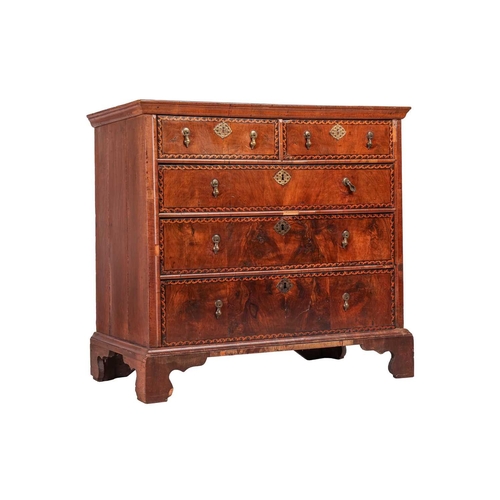 115 - An early 18th-century walnut chest of two short over three long drawers each with 