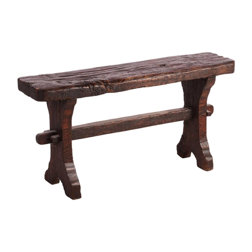 117 - A primitive vernacular oak/elm form stool, 19th century, with thick knarled rectangular top over a b... 