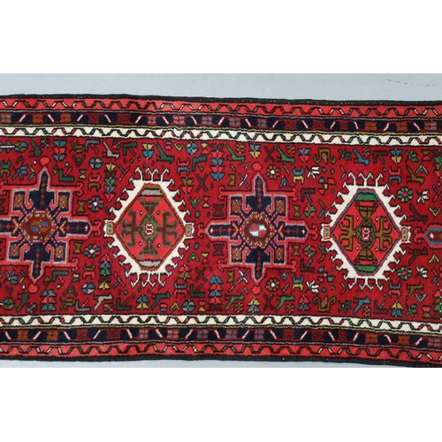 147 - A red ground Karaja strip runner with nice lozenges on a central pole, within multiple borders, 295c... 