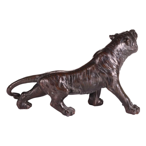 162 - After Seiya, a Japanese bronze patinated spelter figure of a stalking tiger, early 20th century, unm... 