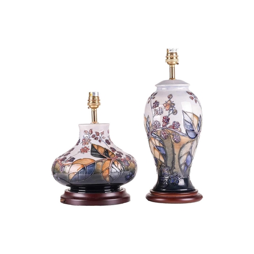 171 - Two contemporary Moorcroft table lamps, in the Blackberry Bramble pattern, each on wooden stand, the... 