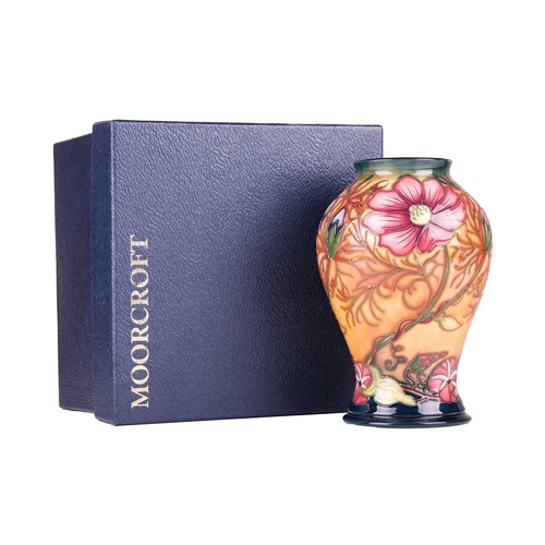 175 - A collection of boxed contemporary Moorcroft items, comprising: a 'Longwing' pattern vase, designed ... 