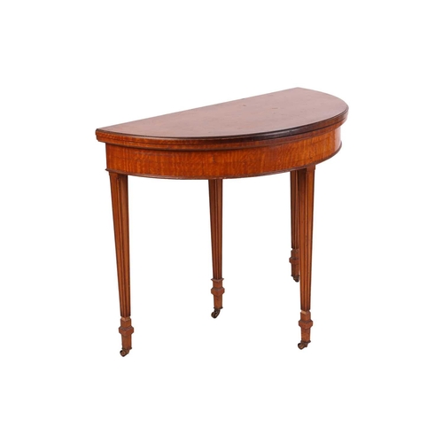 84 - A George III-style demilune satinwood foldover card table, the top opening to reveal inset crimson W... 