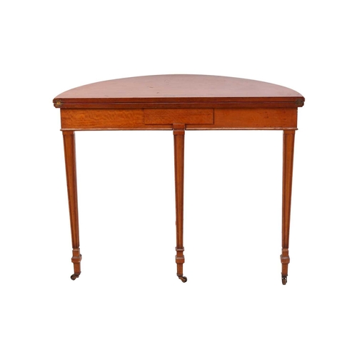 84 - A George III-style demilune satinwood foldover card table, the top opening to reveal inset crimson W... 