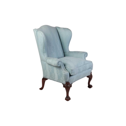 96 - A well-drawn George II-style mahogany wingback armchair. with roll-over arms, upholstered in aqua bl... 