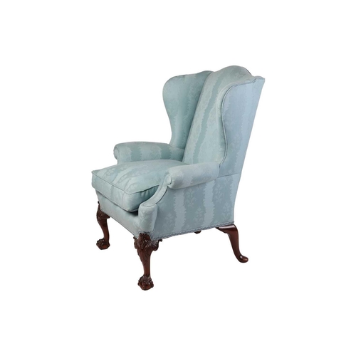 96 - A well-drawn George II-style mahogany wingback armchair. with roll-over arms, upholstered in aqua bl... 