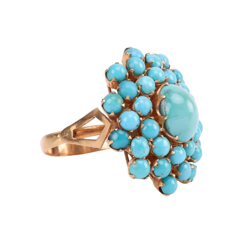 16 - A turquoise cluster dress ring, the central oval turquoise cabochon measuring approximately 10mm x 8... 