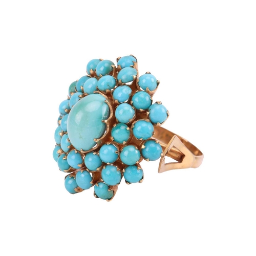 16 - A turquoise cluster dress ring, the central oval turquoise cabochon measuring approximately 10mm x 8... 