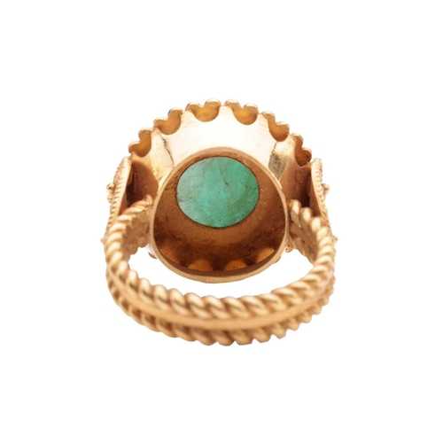 20 - An Etruscan Revival ring set with a carved emerald, the round emerald cabochon of 8.8 x 8.8 x 6.4 mm... 