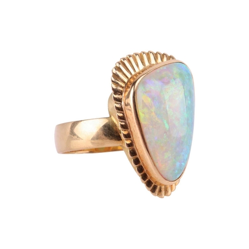 3 - A large opal cocktail ring, the gadrooned triangular head collet-set with a free-formed polished pre... 