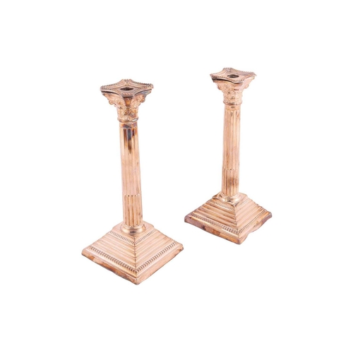 326 - A pair of silver Corinthian column candlesticks, the sconces with beaded borders, each on stepped sq... 