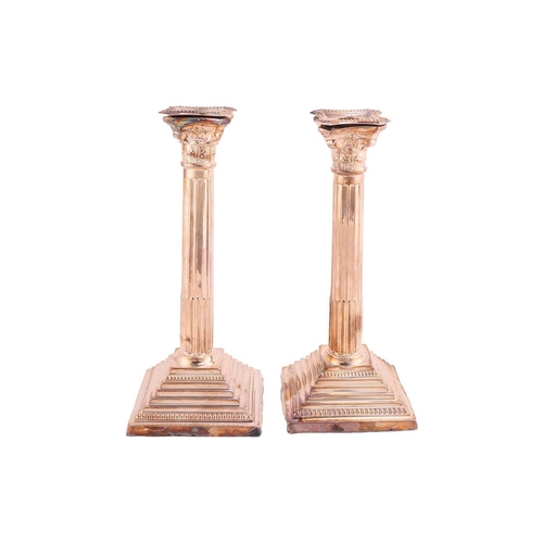 326 - A pair of silver Corinthian column candlesticks, the sconces with beaded borders, each on stepped sq... 