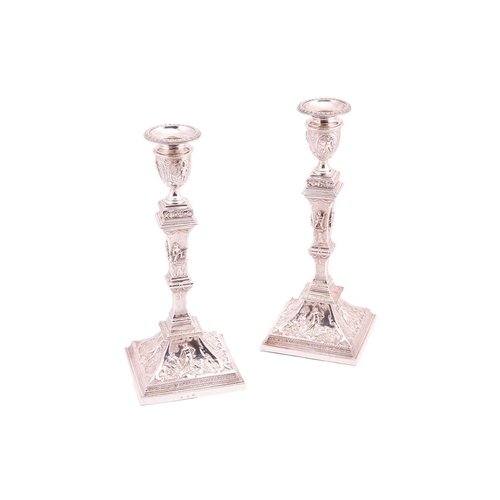 327 - A pair of late 19th century German (?) silver candlesticks; Square with tapering knopped stems, urn-... 