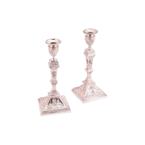 327 - A pair of late 19th century German (?) silver candlesticks; Square with tapering knopped stems, urn-... 