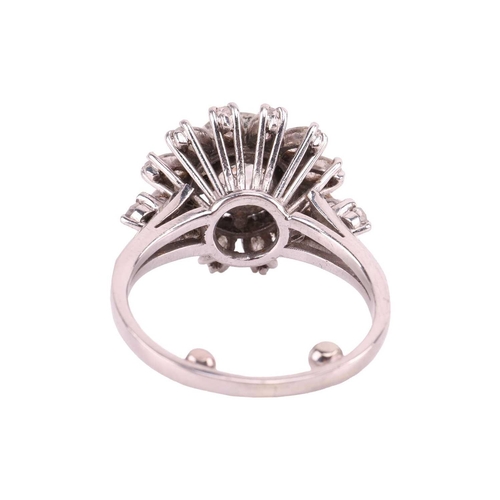 34 - A diamond daisy cluster ring, with an estimated total diamond weight of 2.15ct, centred with an old-... 