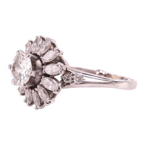 34 - A diamond daisy cluster ring, with an estimated total diamond weight of 2.15ct, centred with an old-... 