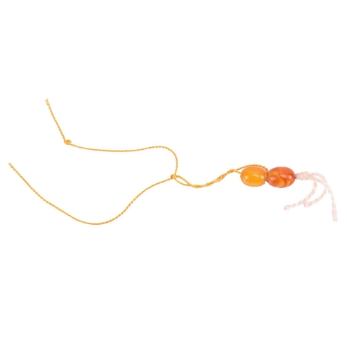 35 - Two amber bead necklaces; a row of butterscotch graduated oval amber beads from 15.0 mm in length to... 