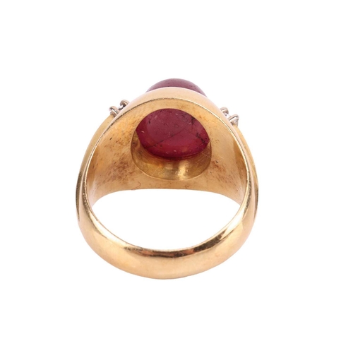 44 - A ruby and diamond dress ring, gypsy mount centred with an oval ruby cabochon of 10.5 x 8.9 x 5.8 mm... 