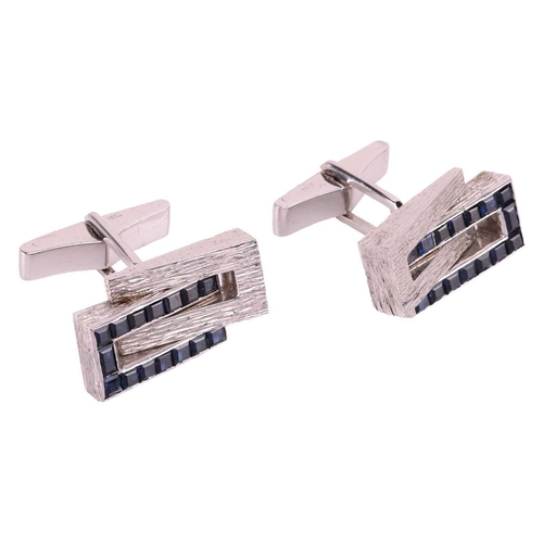 45 - Kutchinsky - a pair of cufflinks set with sapphires; of geometric design with bark effect finish, ch... 