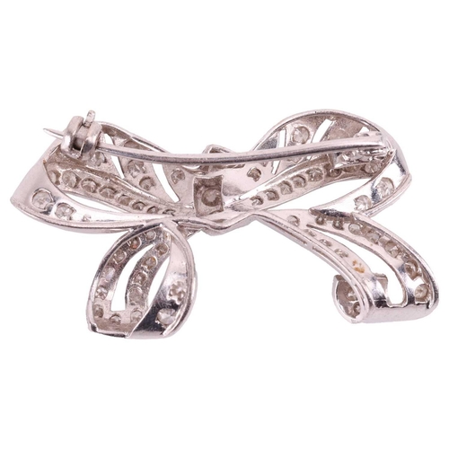 6 - A diamond-set bow brooch of pierced design, claw-set throughout with single and brilliant-cut diamon... 