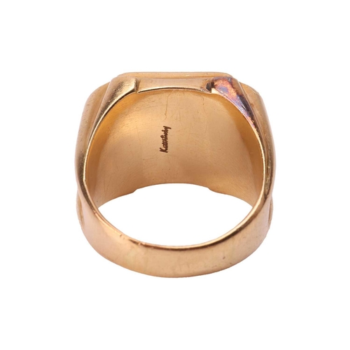 63 - Kutchinsky - a gent's signet ring in 18ct yellow gold, the square ring head cast with initials 'DI',... 