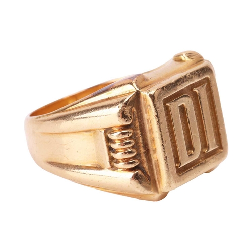 63 - Kutchinsky - a gent's signet ring in 18ct yellow gold, the square ring head cast with initials 'DI',... 