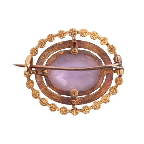 67 - A Victorian amethyst and enamel brooch, the central oval-shaped amethyst set within a 12-claw settin... 