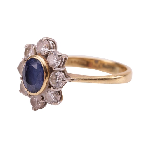 70 - A sapphire and diamond cluster ring, estimated total diamond carat weight 0.96ct, the central collet... 