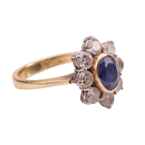 70 - A sapphire and diamond cluster ring, estimated total diamond carat weight 0.96ct, the central collet... 