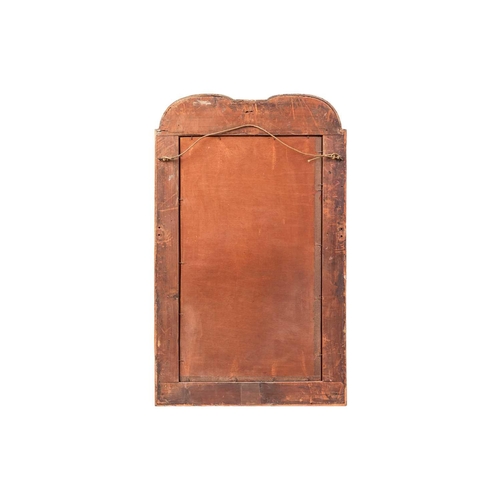 102 - An early 18th-century carved wood and gilt gesso wall mirror, with a double-arched moulded frame, an... 