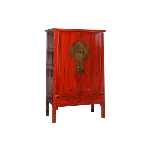 107 - A Chinese red lacquered wedding cabinet, 20th century, with two cupboard doors over two drawers, she... 