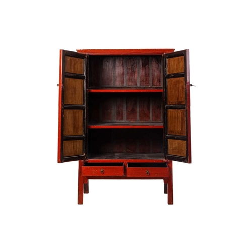 107 - A Chinese red lacquered wedding cabinet, 20th century, with two cupboard doors over two drawers, she... 