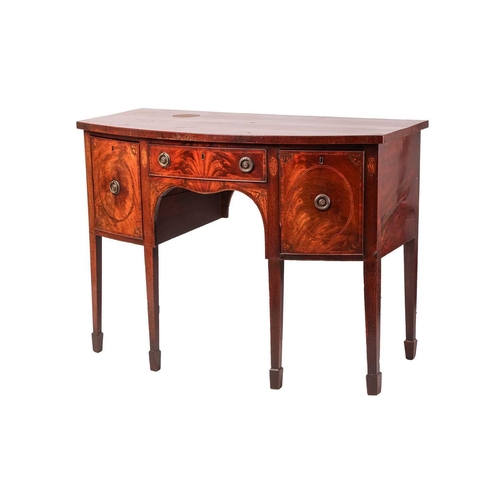 114 - A George III mahogany small bowfront kneehole sideboard, with a central frieze drawer and two deep s... 