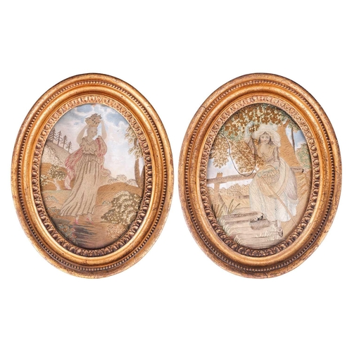 128 - A pair of George III silk work figural pictures, late 18th century, each glazed in a gilt oval frame... 