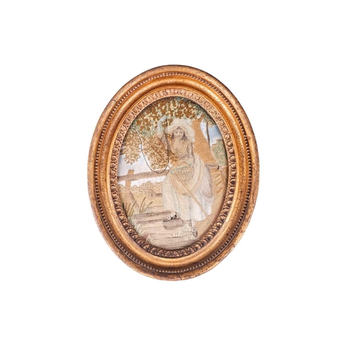 128 - A pair of George III silk work figural pictures, late 18th century, each glazed in a gilt oval frame... 