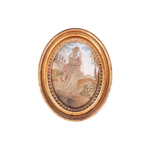 128 - A pair of George III silk work figural pictures, late 18th century, each glazed in a gilt oval frame... 