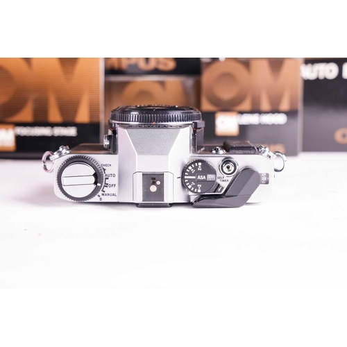 157 - A large collection of boxed Olympus OM System cameras and accessories, comprising: an OM-4 Ti camera... 