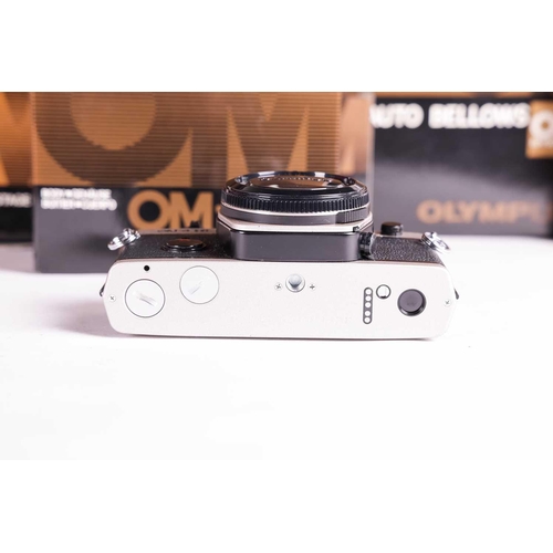 157 - A large collection of boxed Olympus OM System cameras and accessories, comprising: an OM-4 Ti camera... 