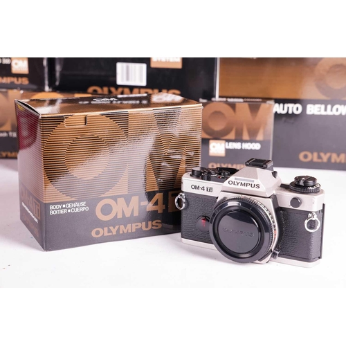 157 - A large collection of boxed Olympus OM System cameras and accessories, comprising: an OM-4 Ti camera... 