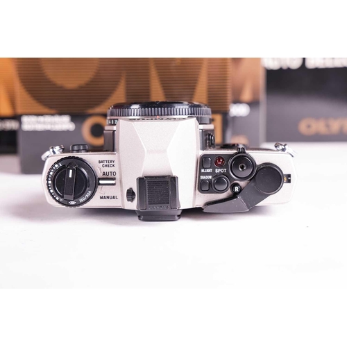 157 - A large collection of boxed Olympus OM System cameras and accessories, comprising: an OM-4 Ti camera... 