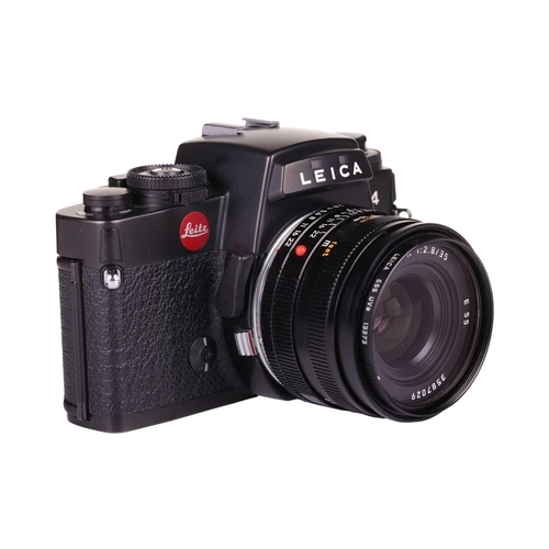 171 - A Leica R4 camera, black, 1983, serial number 1623372, with original instruction booklet, fitted wit... 