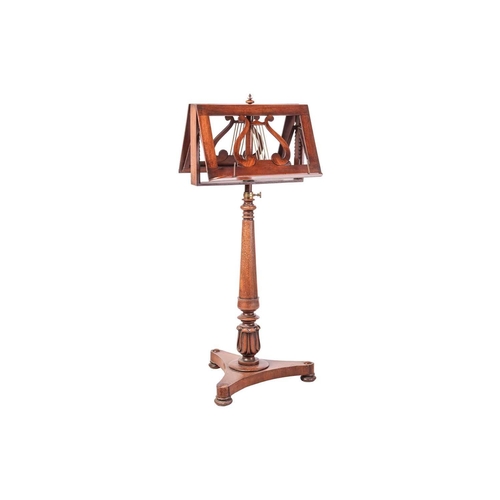 82 - A George IV mahogany duet stand, brass mounted with rise and fall movement, on an inverted tapering ... 