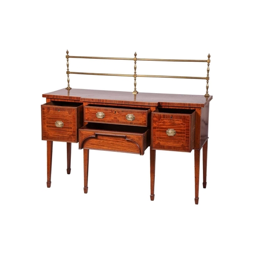 84 - A George III mahogany and inlaid breakfront sideboard, with brass rail to rear, over four drawers, o... 