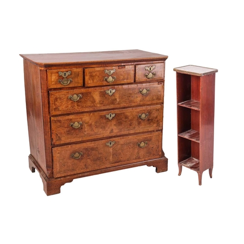 87 - A George I walnut chest, with three short and three long graduated drawers, fluted corners and brack... 