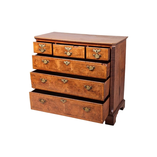 87 - A George I walnut chest, with three short and three long graduated drawers, fluted corners and brack... 