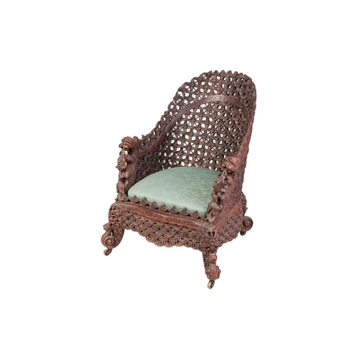 88 - An Anglo-Indian carved hardwood armchair, late 19th century, with lattice work back and front rail, ... 