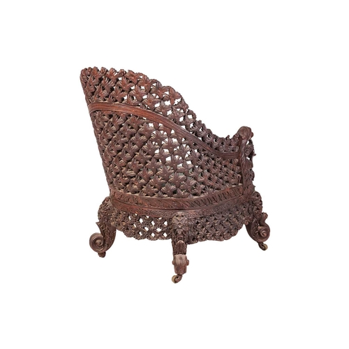 88 - An Anglo-Indian carved hardwood armchair, late 19th century, with lattice work back and front rail, ... 